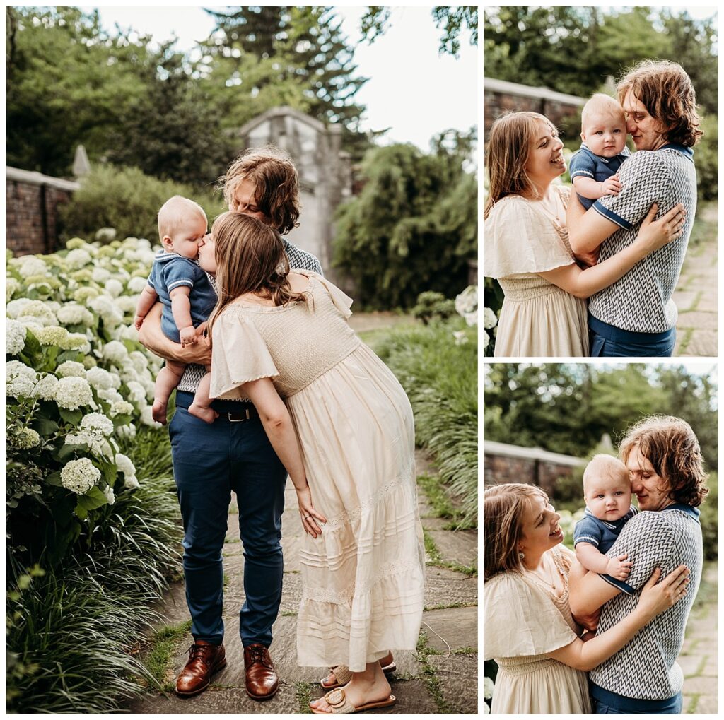 Parents holding their baby son in front of historic brick walls at Mellon Park