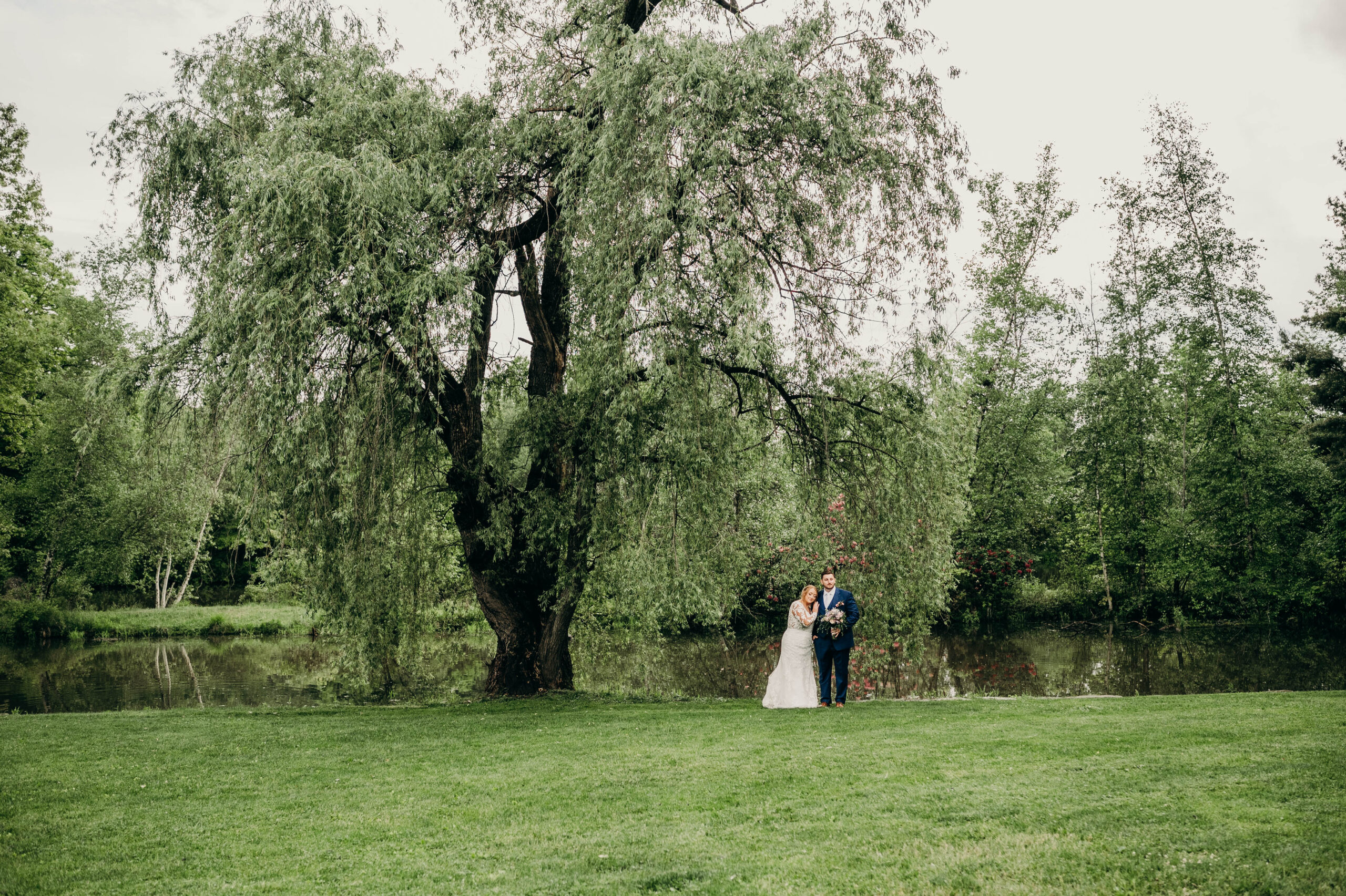 Bride and Groom Pose under Willow tree at Succop Nature Park